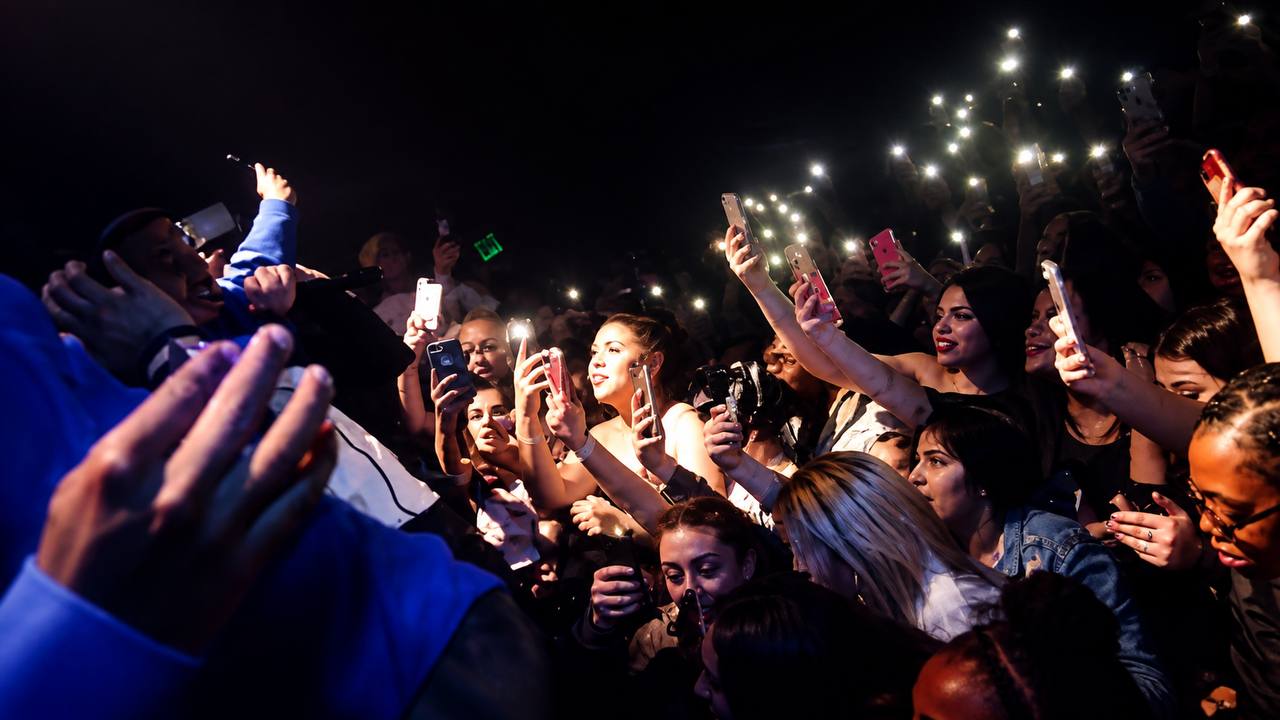 Crowd reaching toward the stage at Teatro Azteca